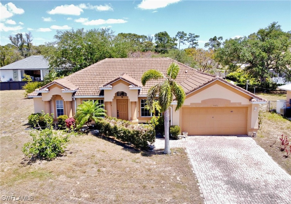 View of front of home featuring a tile roof, an at