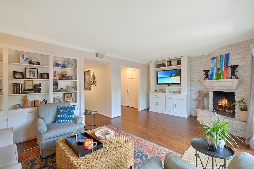 The beautiful wood burning fire place, built-ins and tons of natural light make for a relaxing family room!