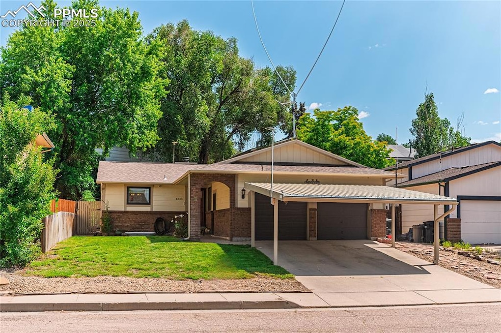 View of front of house featuring brick siding, an attached garage, and concrete driveway with carport