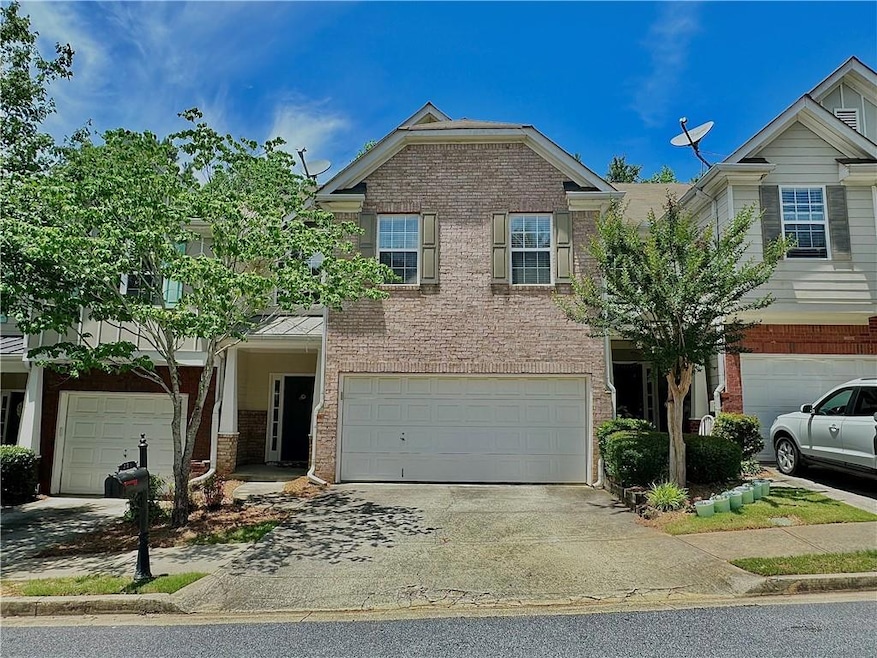 View of front of home featuring brick siding, an attached garage, and concrete driveway
