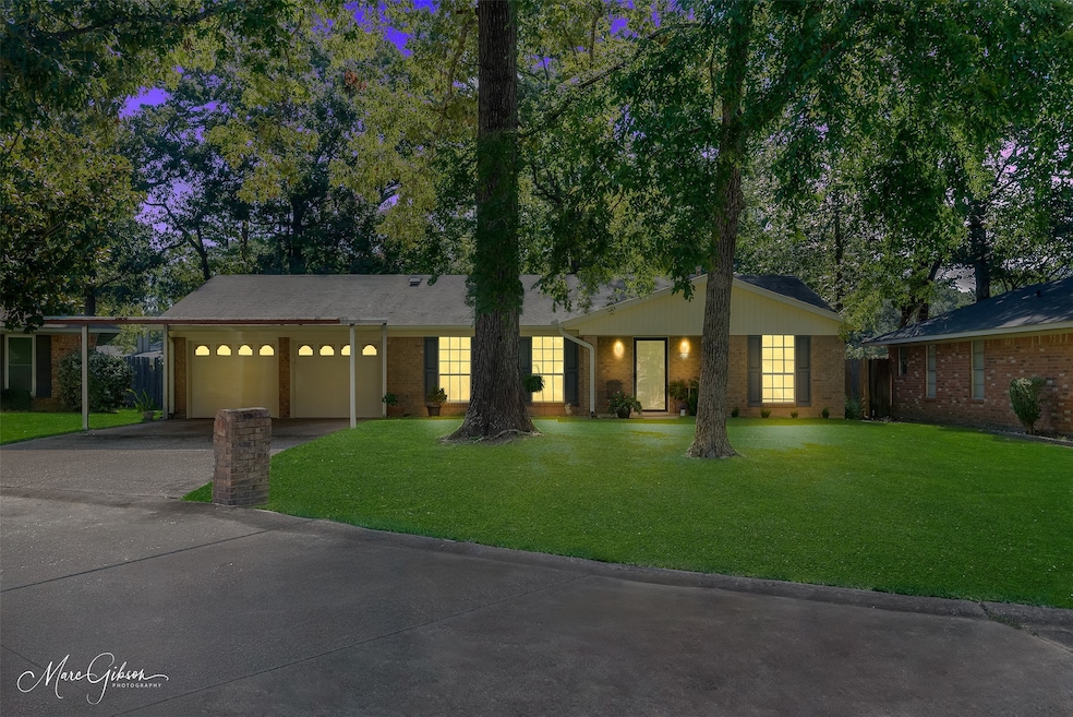 Ranch-style home with concrete driveway, a garage, brick siding, and a front lawn