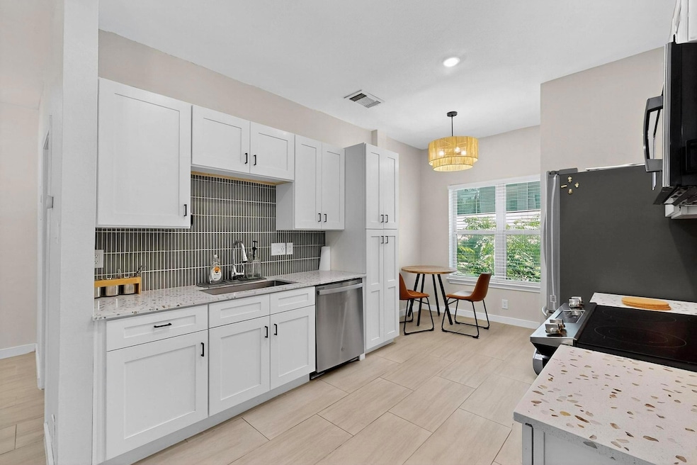 Kitchen featuring stainless steel appliances, whi