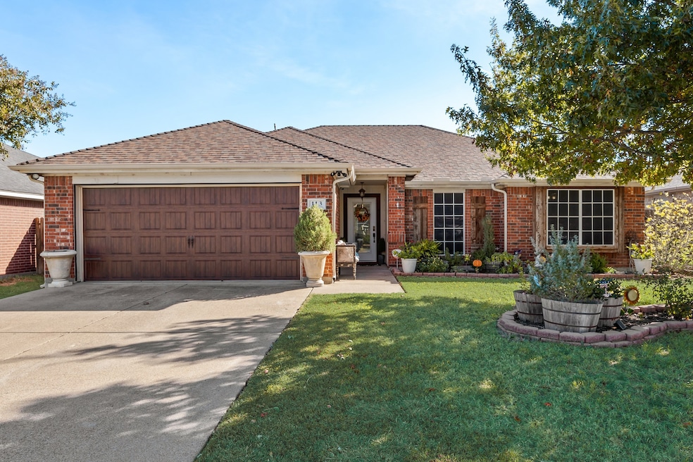 Ranch-style home featuring brick siding, roof with shingles, and a front lawn