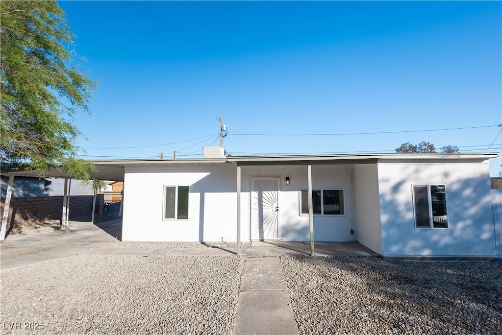 View of front of home with stucco siding and fence