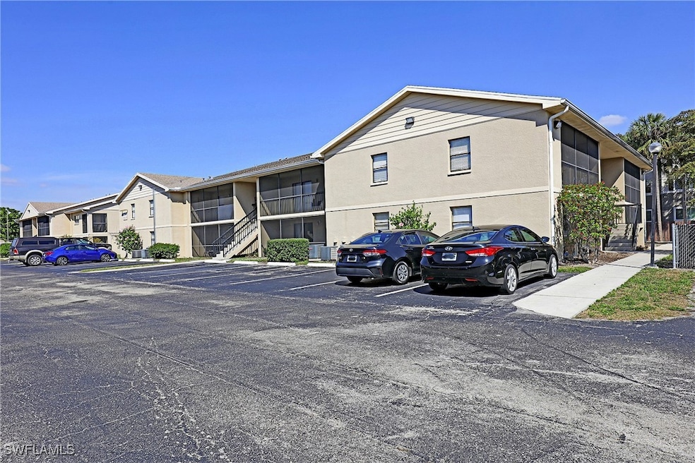 View of property featuring uncovered parking