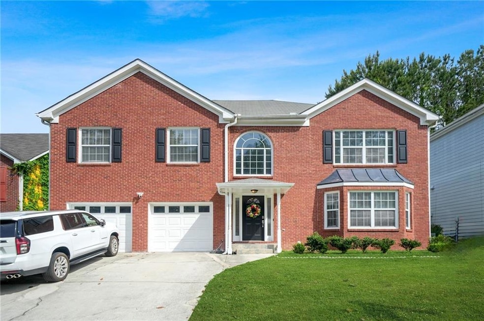 View of front of home featuring concrete driveway,