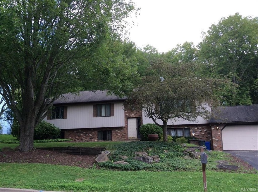 Front view of home, natural landscaping