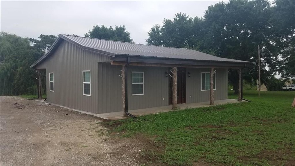 Metal sided home with unique timber accents.