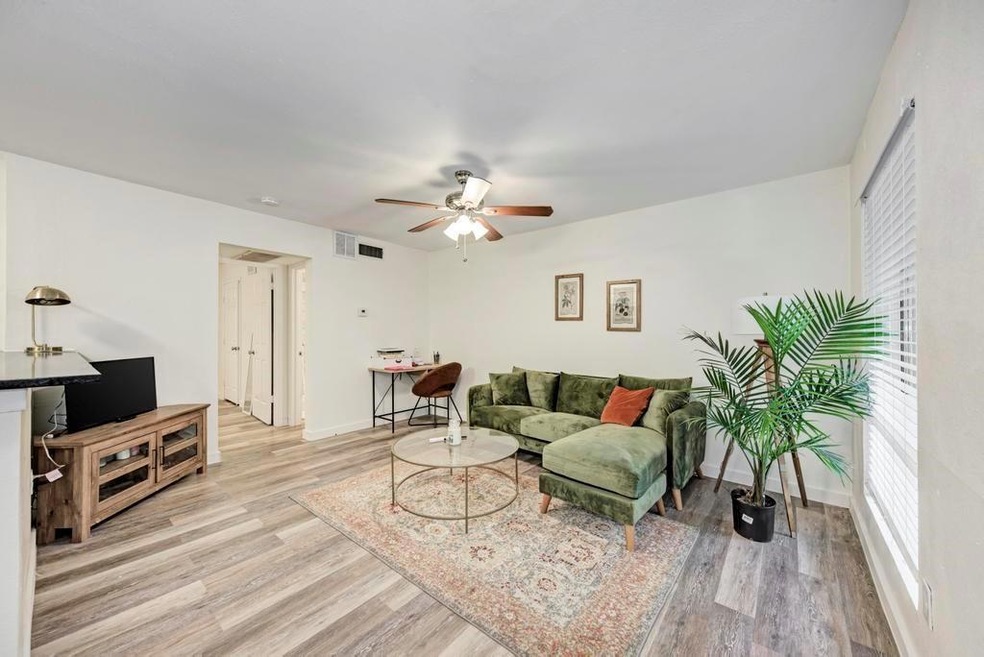 Living area featuring baseboards, visible vents, 