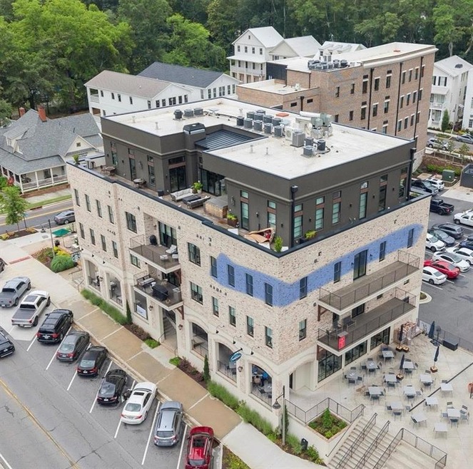 Unit is highlighted in blue, balcony spans the length of the living and kitchen area