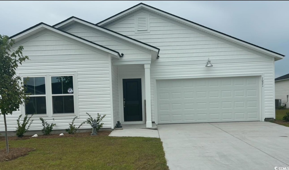View of front facade featuring a garage