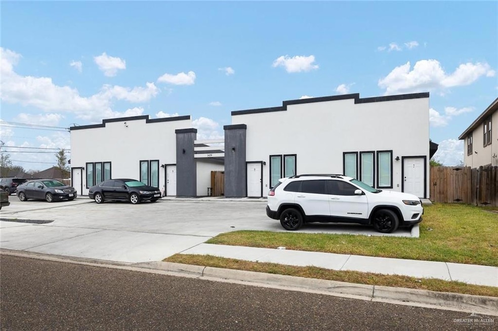 View of front of property with stucco siding and fence