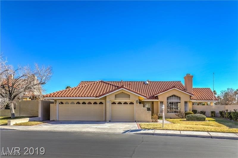 Mediterranean / spanish house featuring a tile roo
