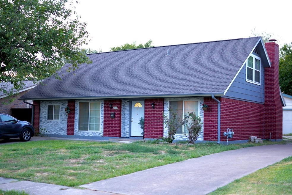 View of front facade with a shingled roof, a chimn