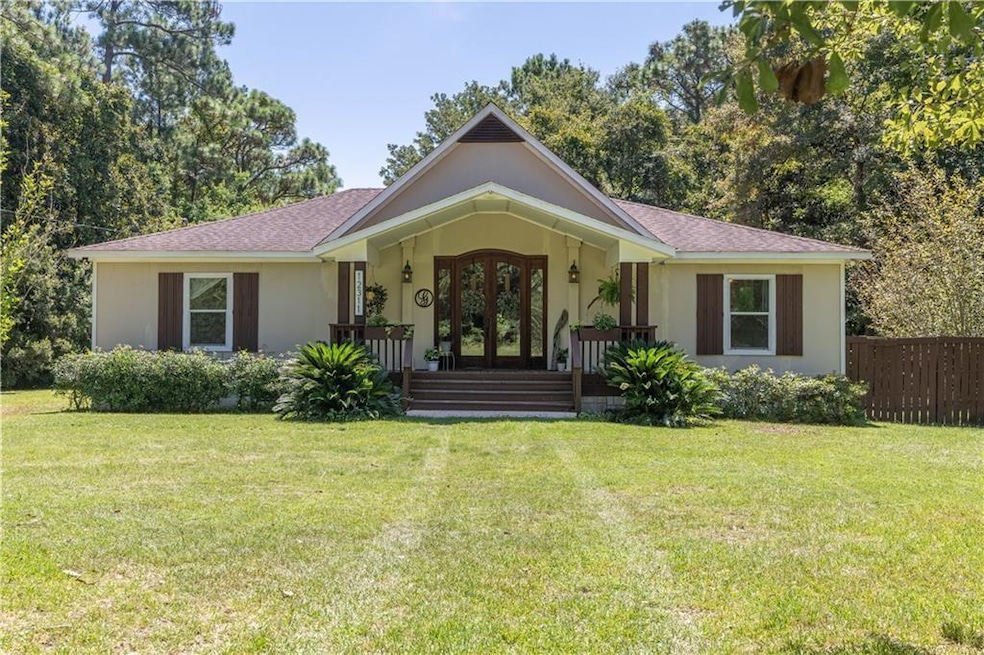 Ranch-style home with french doors, fence, stucco 