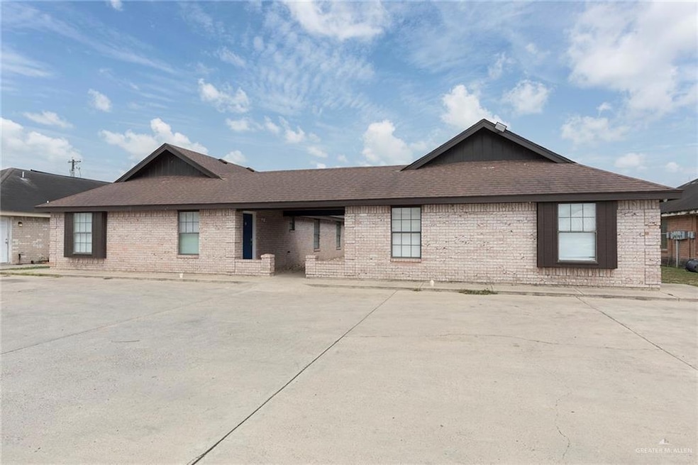 Single story home with a shingled roof and brick siding