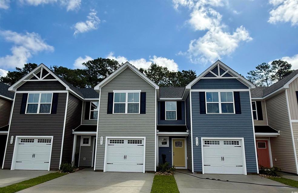 Townhome / multi-family property with driveway, a 