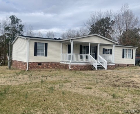 View of front of home featuring crawl space, cover