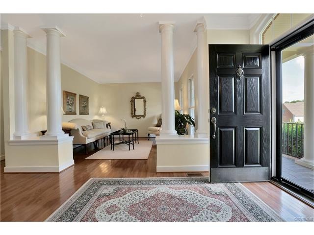 Bright foyer which opens to the living room and the dining room.