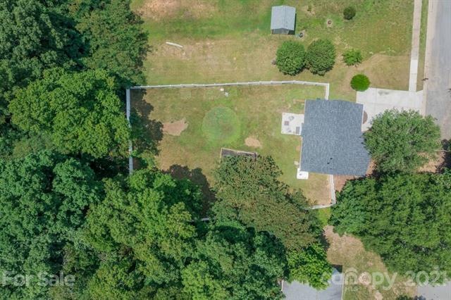 .63 acre extends into woods behind home