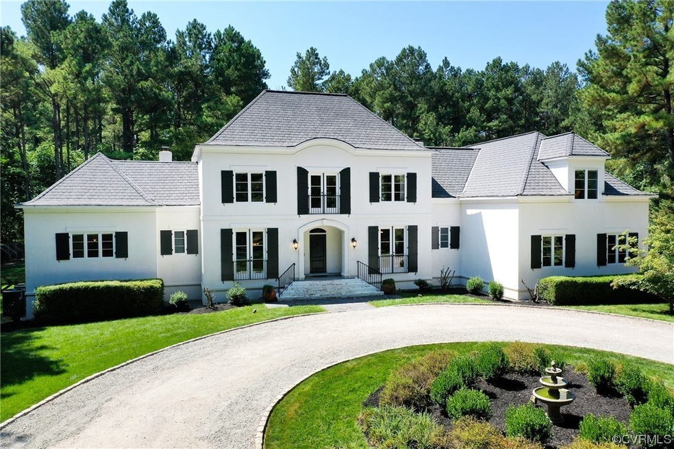 French country inspired facade with a front lawn