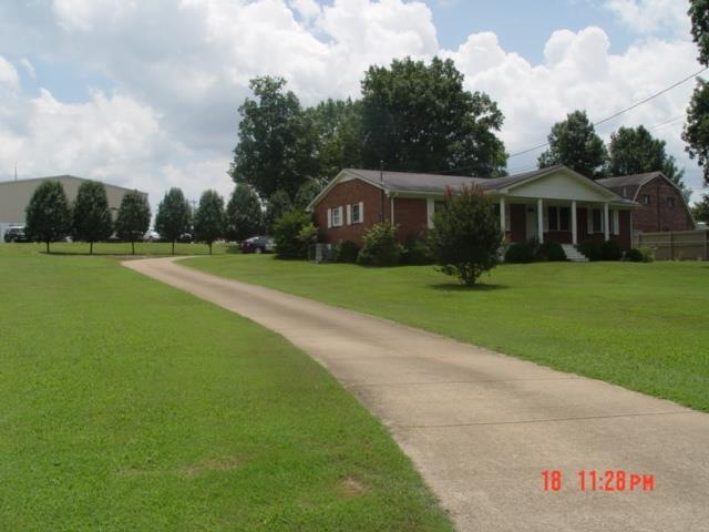 Concrete driveway leading the double car carport