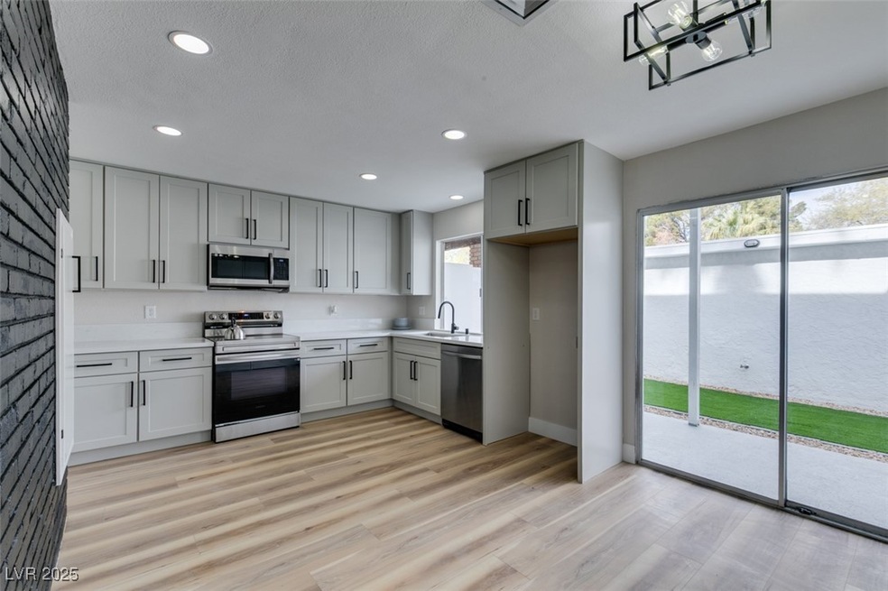 Kitchen featuring light countertops, light wood-st