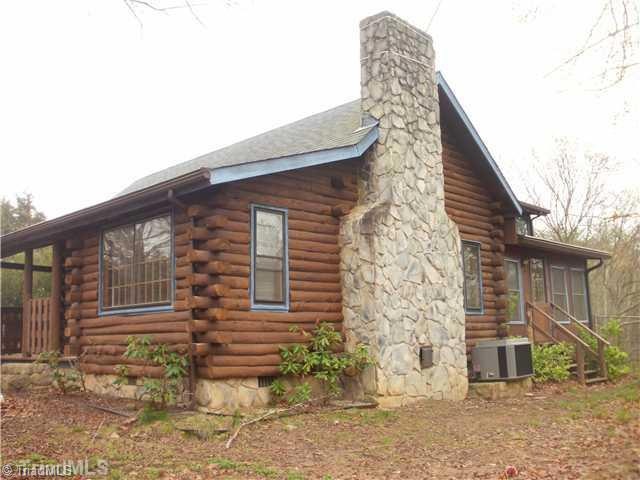 Exterior Front. 3 BR, 2 BA Log Cabin!  Huge Rock Fireplace, enclosed porches, numerous outbuildings.  Enjoy almost 17 acres of privacy!