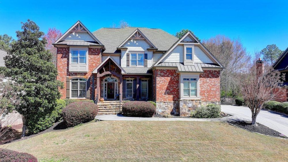 View of front of property with brick siding, a sta