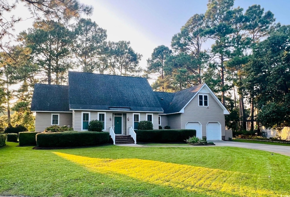 Cape cod-style house featuring a garage and a fron