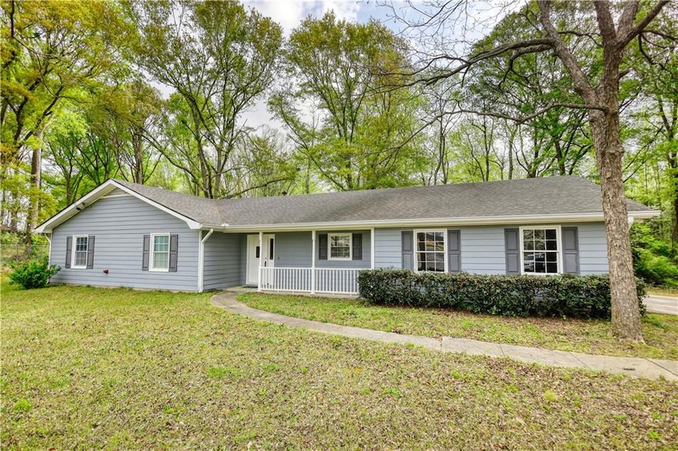 Ranch-style house featuring roof with shingles, a 