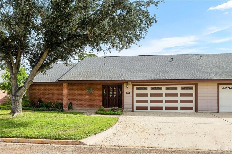 Ranch-style house featuring a garage and a front lawn