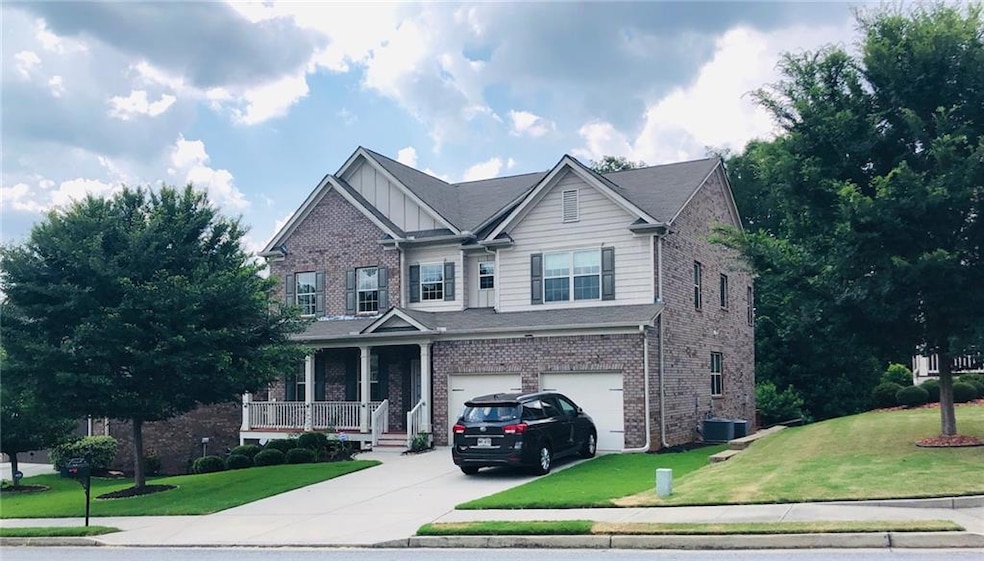 View of front of house featuring a front lawn, cov