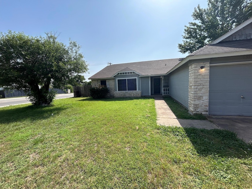 Ranch-style house with a front lawn, stone siding