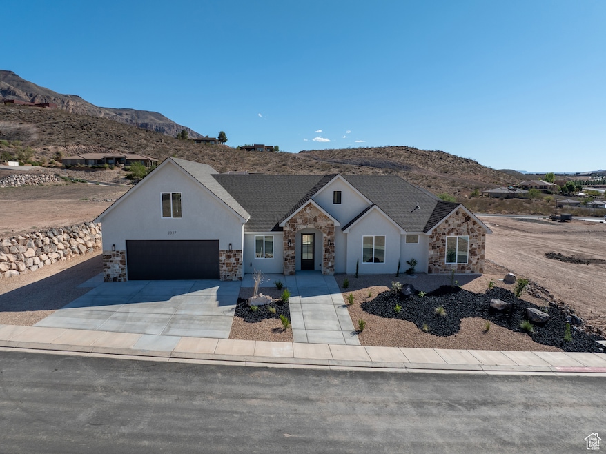 Modern farmhouse with a mountain view, stone siding, driveway, a garage, and stucco siding