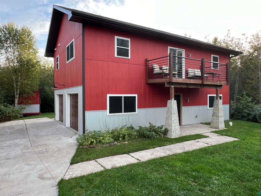Exterior space with a balcony, a garage, and a fro