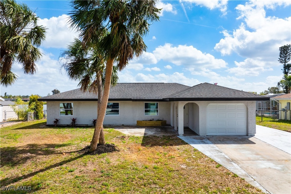 Ranch-style house with stucco siding, fence, drive