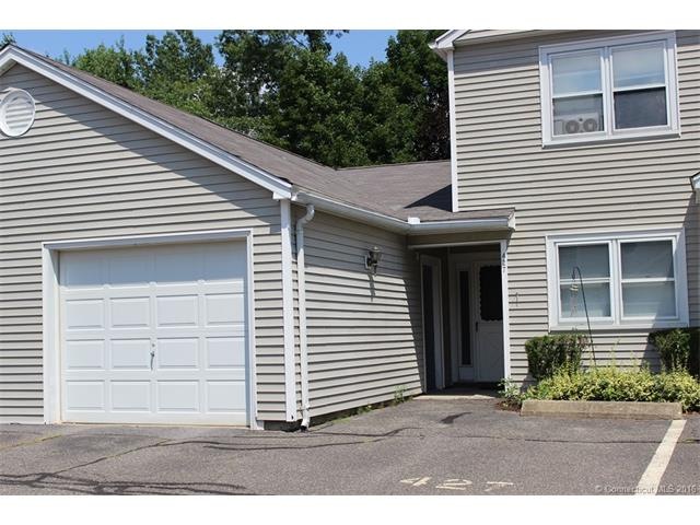 Exterior front with garage and parking space