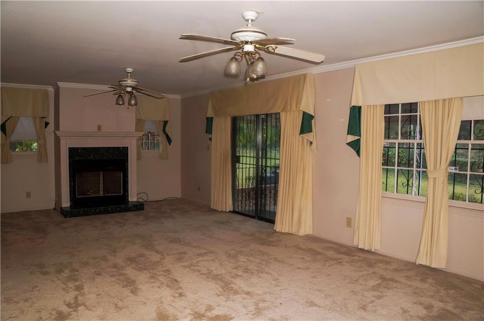 Unfurnished living room with carpet floors, orname