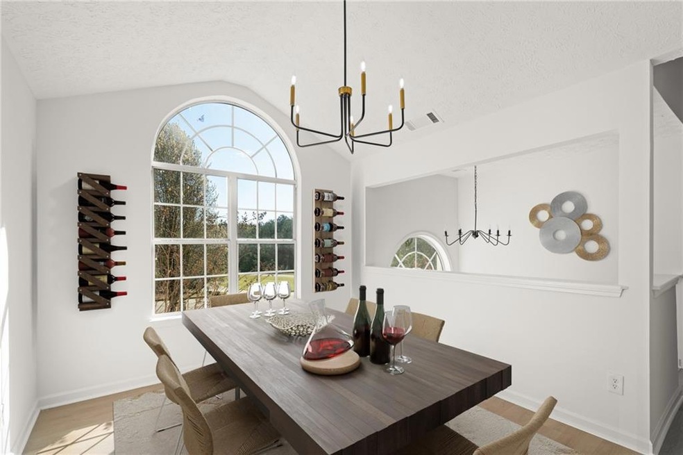 Dining room with an inviting chandelier, lofted ce