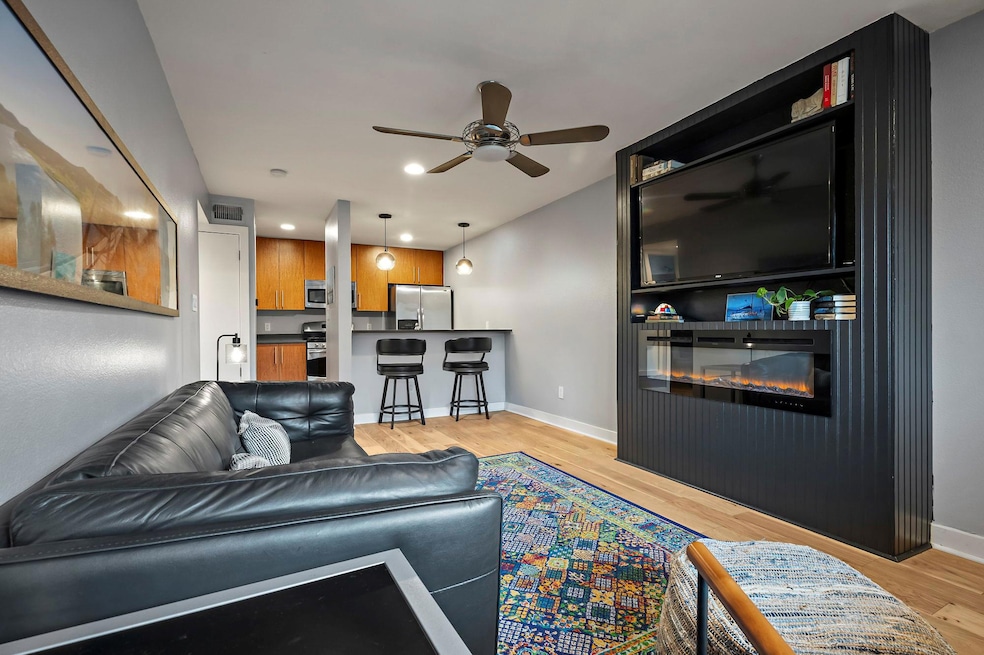 Living room featuring light wood-style floors, a 