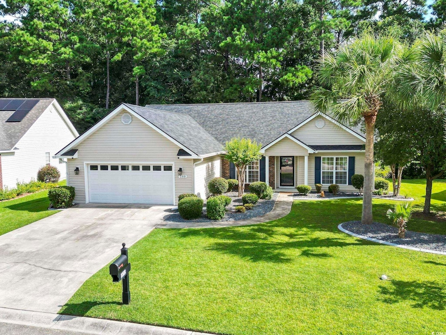 Ranch-style house with concrete driveway, a shingled roof, an attached garage, a front yard, and a porch