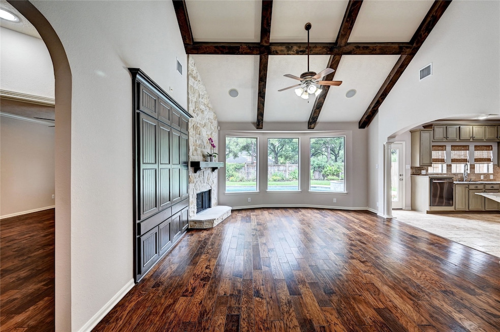 This spacious living room features wooden built in
