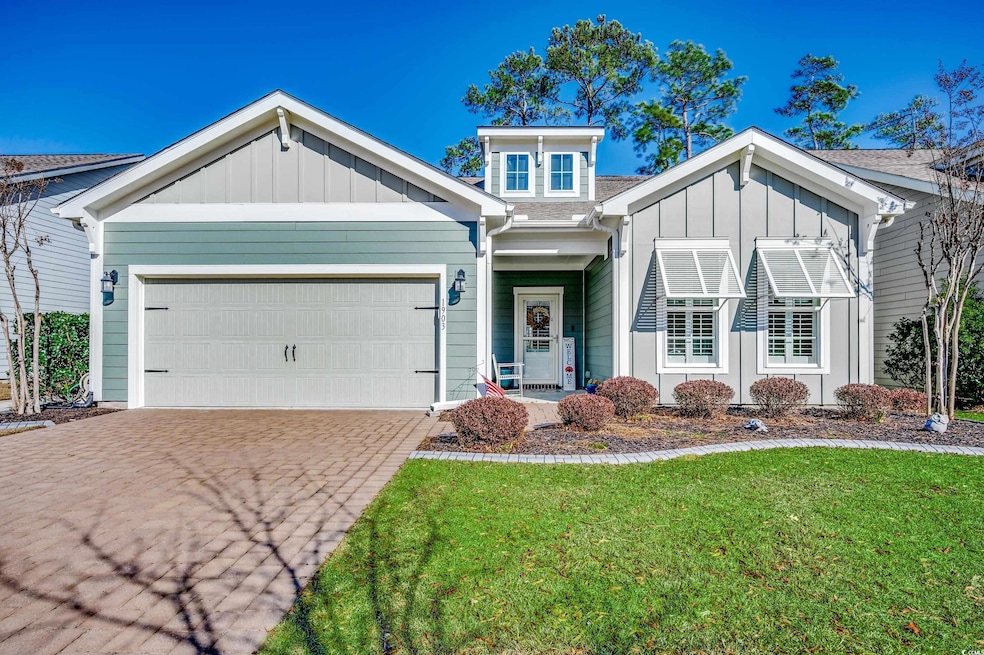 View of front of home featuring a garage and a front yard