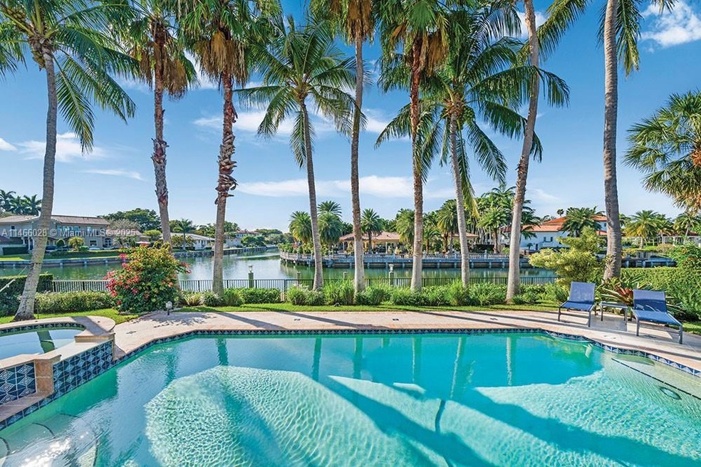 Expansive Waterfront Retreat with Terraces Overlooking Pool and Lush Greenery!