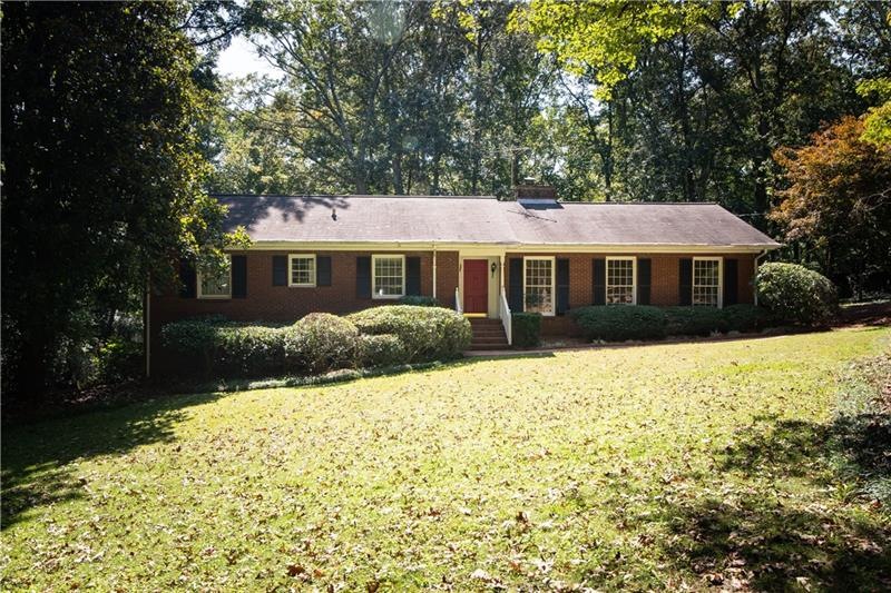 Sprawling four sided brick ranch on over an acre i
