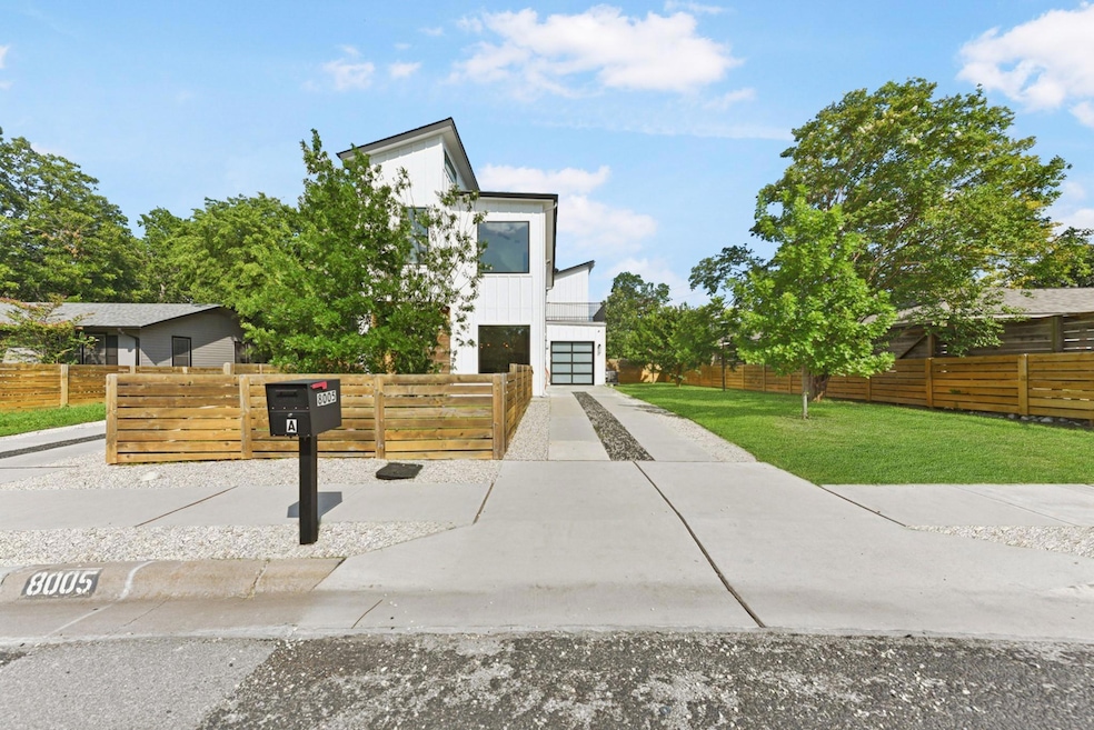 Contemporary home featuring concrete driveway