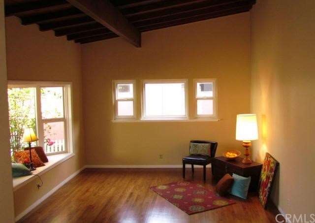 Wood beam ceilings crown this gem. A welcoming bay