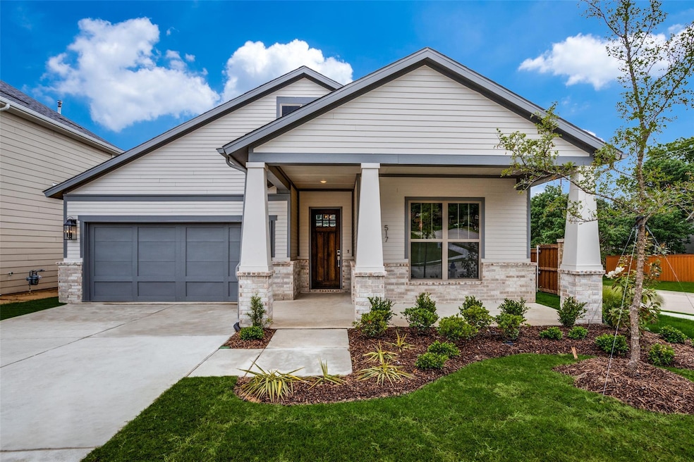 Craftsman-style house with a garage, covered porch