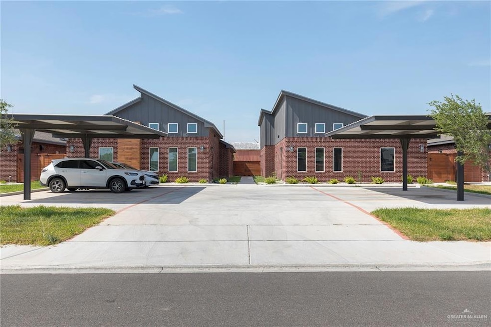 View of front of property with board and batten siding, brick siding, and covered and uncovered parking